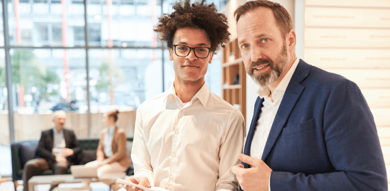 Guiding the Balancing Act: Mentorship in Risk Management A seasoned risk manager offers guidance to a new risk manager in the office, discussing strategies for Balancing Risk, Control, and Productivity.