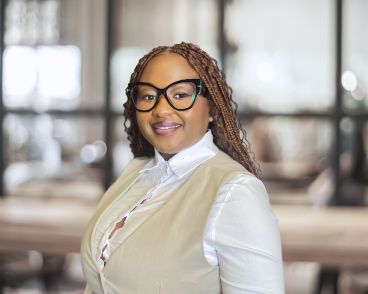 Eslyn Jairos Account Development Manager - Revival Holdings Eslyn Jairos, Account Development Manager at Revival, smiles for her headshot against a corporate office background.