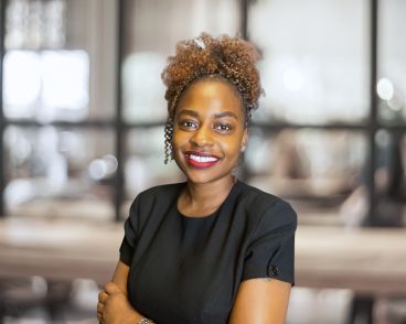 Nafula, a Sales Executive for Revival in Kenya, smiles as she poses for her headshot.